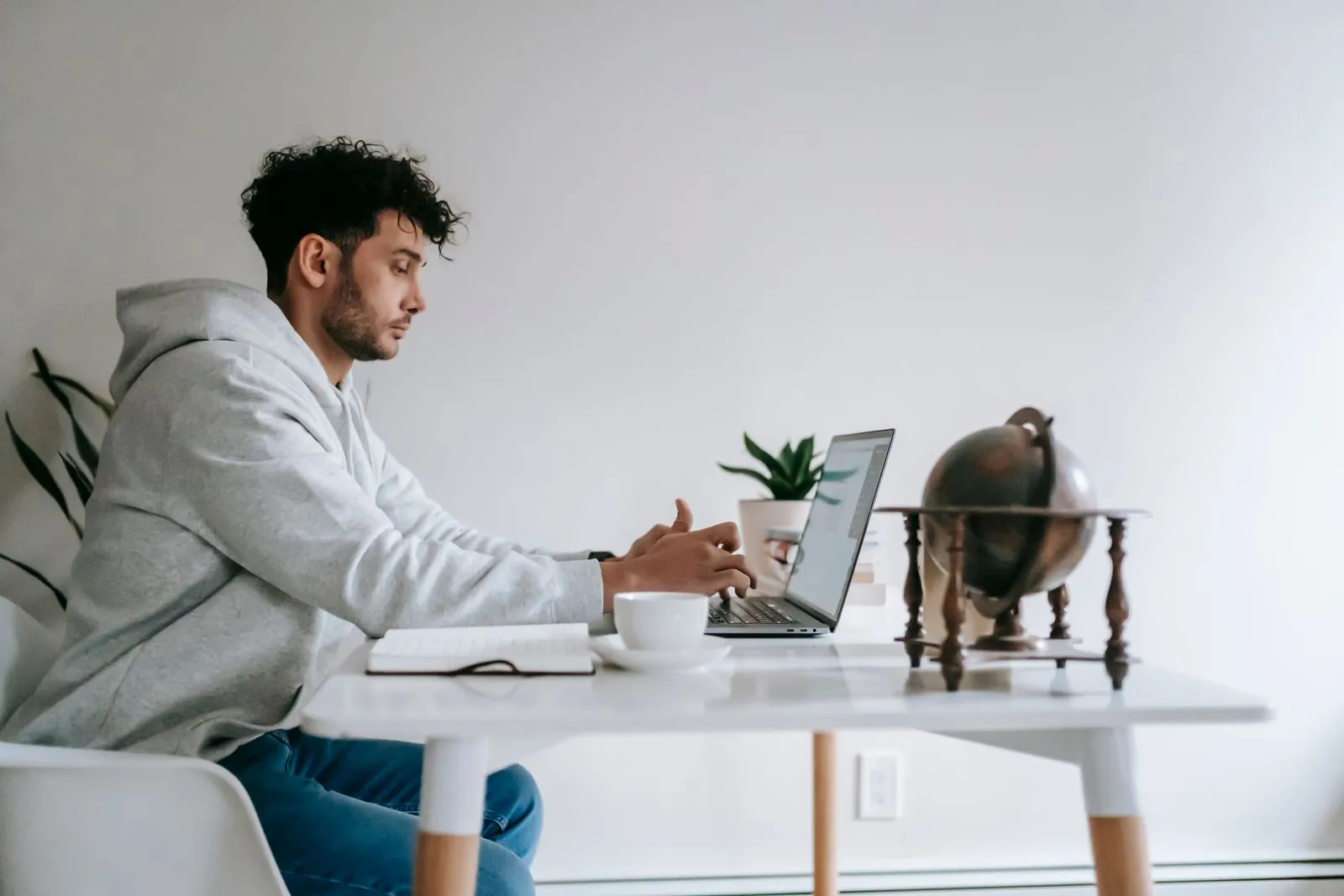 Freelancer writing a tailored Upwork proposal on a laptop at home
