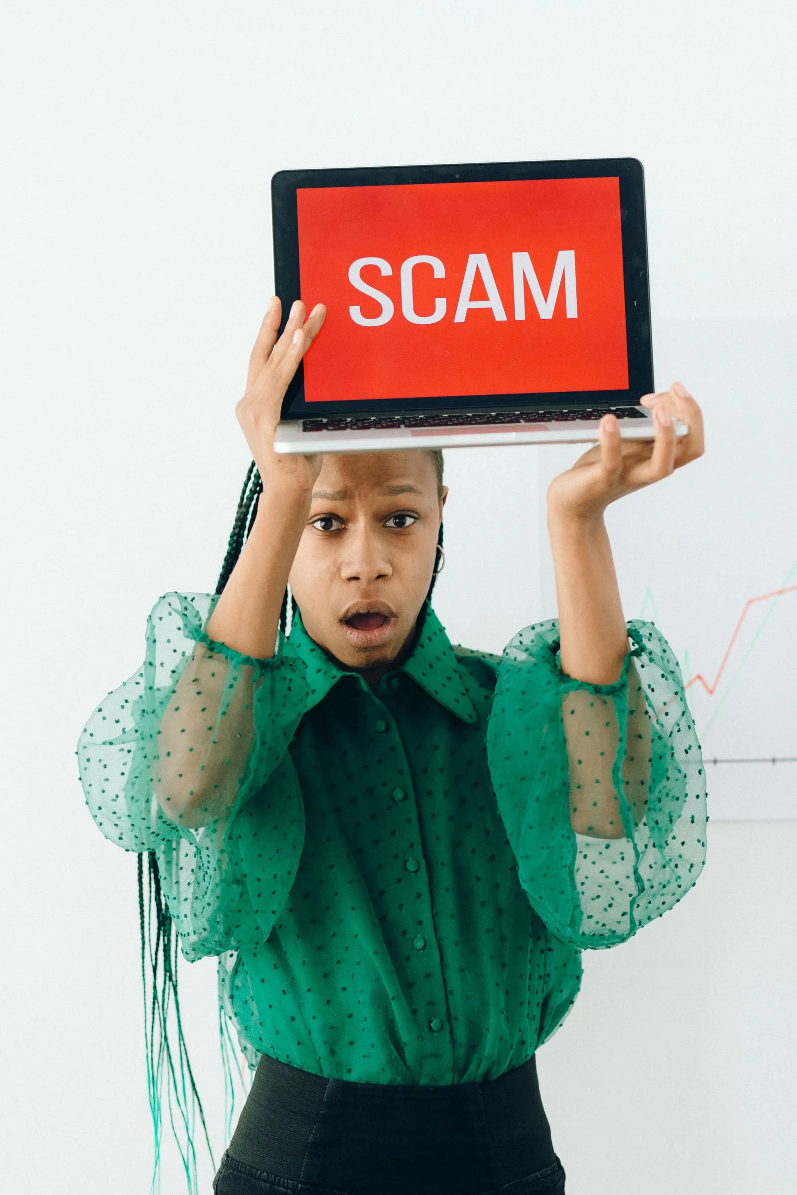 Laptop displaying a scam warning for remote job seekers